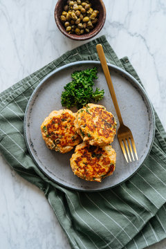 Grilled fish cutlets on metal plate