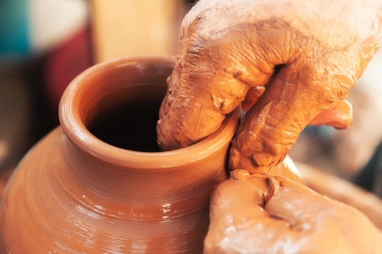 Crop potter making pot in workshop