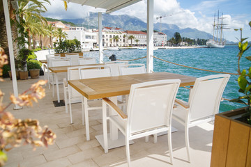 Cozy empty open cafe on the sea promenade, Tivat, Montenegro.