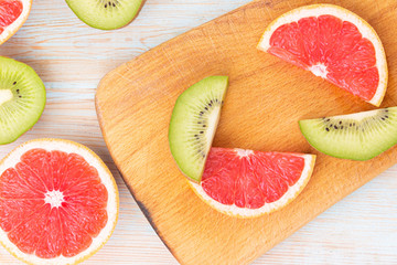 Slice kiwi, grapefruit pattern on wooden background. copy space.