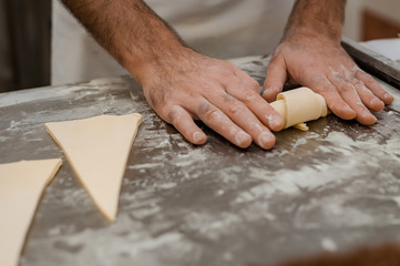 The process of making croissants in a bakery.