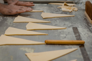 The process of making croissants in a bakery.