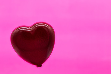 Valentine's Day love concept, single red heart on pink background. St. Valentine's Day concept background with copy space. Valentine's Day background