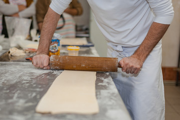 The process of preparing puff pastry in a bakery.