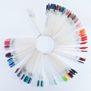 fan with multicolored nail samples on a light background in a nail salon, copy space