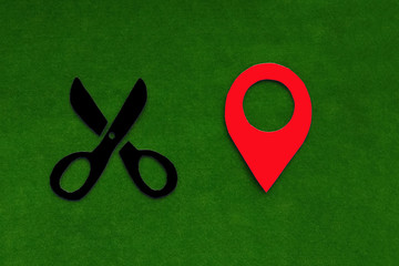 Scissors, geolocation sign on a green background. Location of the Barber's services.