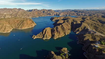 beautiful aerial shot of lake surrounded by mountains © SobrevolandPatagonia