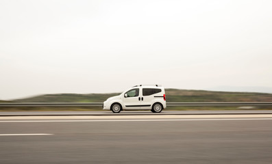 Obraz na płótnie Canvas Speedy Delivery Van On Highway