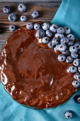 chocolate cake with fresh blueberries on a blue towel, close-up, pie,
