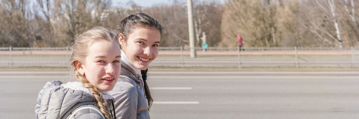 Fototapeta premium young women walking and talking on street