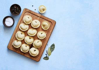 Ravioli with meat cooking process on the kitchen table. View from above.