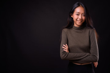 Portrait of happy young beautiful Asian woman