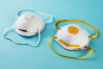 Medical face mask on blue background. Protective surgical mask,