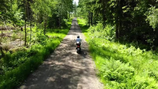 Drone follows motorbike in Swedish forest