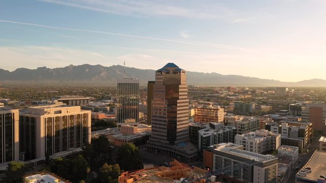 Cityscape Of Tucson Downtown With Santa Catalina Mountain Range On The Background In Arizona, USA On A Sunny Summer Day.-  aerial shot