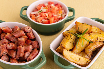 portion of roasted potatoes and sausage and vinaigrette