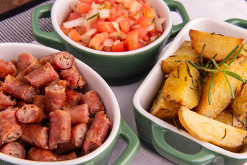 portion of roasted potatoes and sausage and vinaigrette