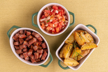 portion of roasted potatoes and sausage and vinaigrette