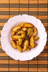portion of roasted potatoes with olive oil and rosemary