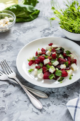 Baked beets with feta cheese and shoots of young peas