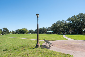 Lamp post and bench in park in Lakeview neighborhood of New Orleans, Louisiana, USA
