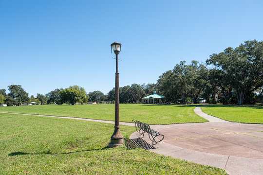 Lamp Post And Bench In Park In Lakeview Neighborhood Of New Orleans, Louisiana, USA