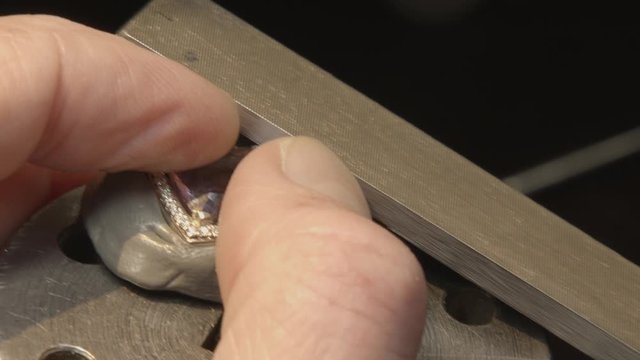 Goldsmith Filing A Ring.Close up