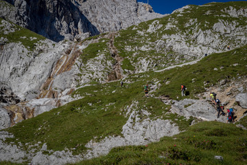 Woman's crossing via via ferrata in the alps