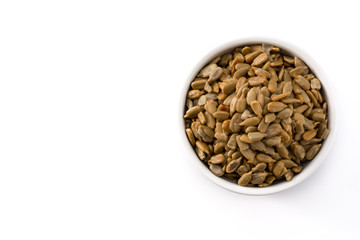 Sunflower seeds in bowl isolated on white background. Top view. Copy space