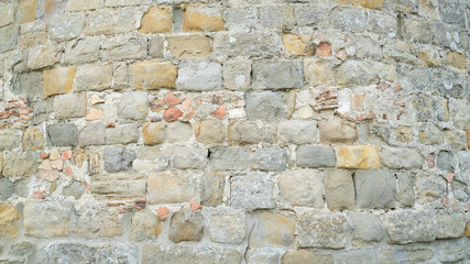 Natural stone wall texture. Medieval masonry. Ancient wall. Stone brick wall. Macro texture. Medieval architecture. Rough masonry. Background texture.