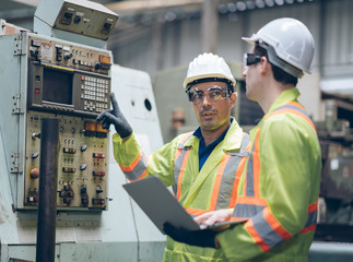 technician engineer and mentor operate heavy machine to automated CNC in factory