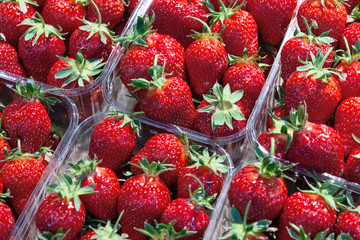 View of ripe strawberries that lies in containers. The concept of healthy food, berries, background.