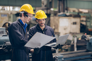 technician engineer looking on paper document in factory
