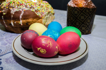 Fototapeta na wymiar Easter concept. Easter cake, multi-colored eggs on the festive table.
