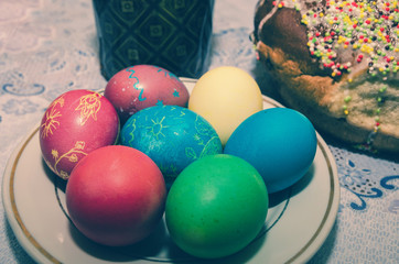 Easter concept. Easter cake, multi-colored eggs on the festive table.