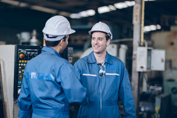 professional technician engineer and mentor shake hand in factory