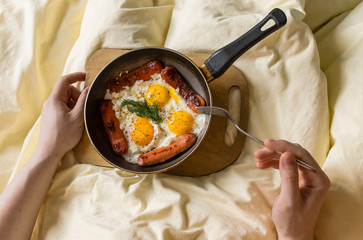 Fried eggs with sausage in an old pan