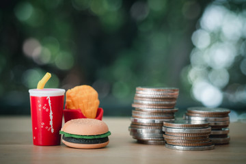 Stack of coin and junk food