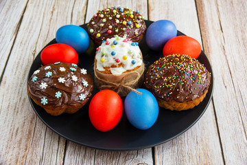 Decorated cakes in chocolate glaze and colored eggs
