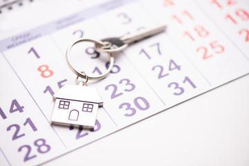 A house key on a calendar background