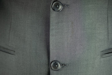 Black button on a man suit background.