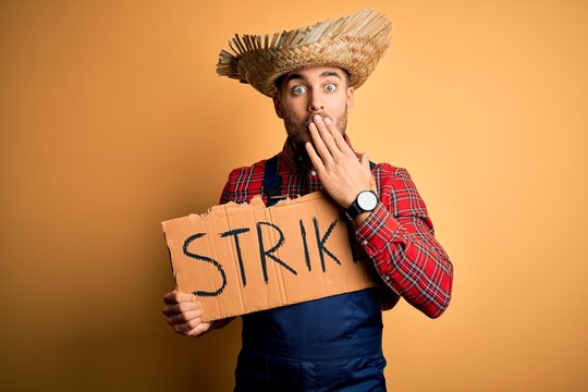 Young rural farmer man wearing countryside hat on strike prostest for salary cover mouth with hand shocked with shame for mistake, expression of fear, scared in silence, secret concept