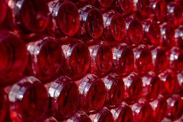 Rows of red wine bottles, concept of winery.