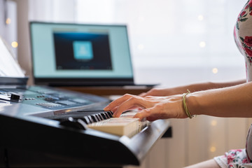 Playing a musical instrument at home, synthesizer and piano