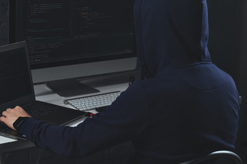 young guy behind a laptop, a hacker