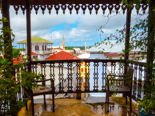 Stone Town, Zanzibar - Tanzania: A beautiful balcony with view over colourful rooftops on the historic old town