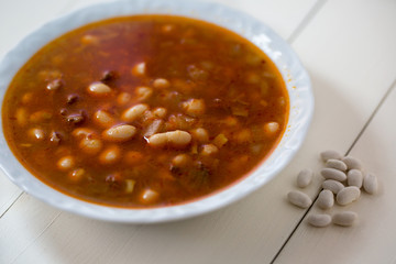 traditional Turkish food Kuru Fasulye in a white plate