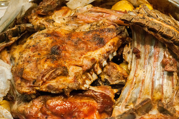 Oven roasted lamb ribs with potatoes closeup