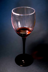 Glass of red wine on a dark background