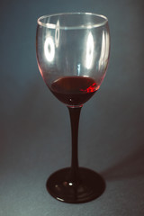 Glass of red wine on a dark background